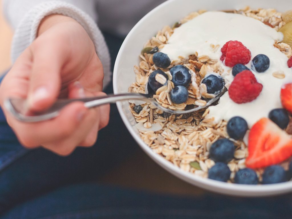 Woman Eating Oatmeal and Berries