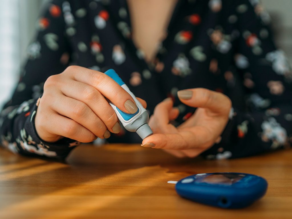 Diabetic pricking fingers to check blood glucose