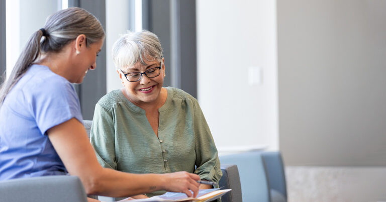 A nurse reviewing paperwork with a patient