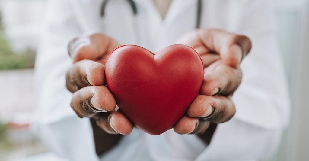 Doctor holding a heart; HAP Donate Life Challenge